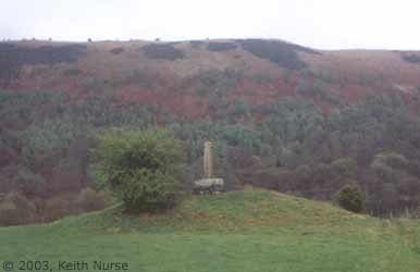 Eliseg's Pillar - a monument that still dominates the land of a long inheritance. The position on top of a Bronze Age burial mound can clearly be seen in this side-view of the monument. Keith Nurse, May 2003.
